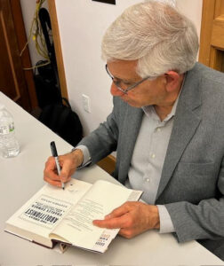 Steve signing a book